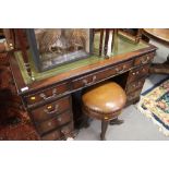 A mahogany double pedestal desk with tooled green leather top, fitted nine drawers, on bracket feet,
