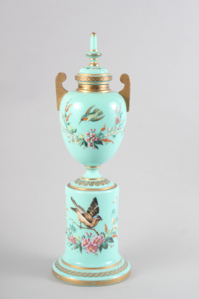 A 19th century Continental green glass and enamelled two-handled vase and cover with bird and flower