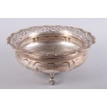 A silver bowl with pierced rim and three scrolled feet, 29.1oz troy approx