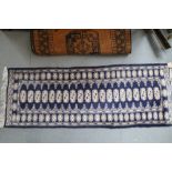 A Bokhara runner with 20 guls on a blue ground and multi-borders in shades of cream and blue, 25"