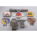 Seven metal and enamel car badges, including "Sunbeam Talbot Owners Club" and "Aston Martin Owners