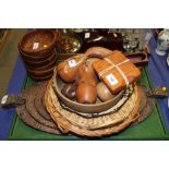 A nest of six carved hardwood trays, six wooden bowls, wooden fruit and other items