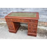 A figured mahogany double pedestal desk with green tooled leather lined top, fitted nine drawers, on
