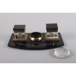 A 1930s black glass desk inkstand, 11" wide (two feet missing) and a desk weight