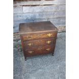 A late 18th century provincial oak chest of three long drawers, on shaped supports, 25" wide x 18"