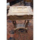 A Far Eastern carved hardwood work table with temple and dragon decoration, on shaped supports