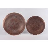 Two Turkish hammered copper and silver inlaid wall plates, larger 14" dia