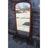 A mahogany cheval mirror of Victorian design with arch top plate, 72" high overall
