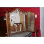 A 19th century mahogany oval swing frame toilet mirror, on skeleton stand with bone details, 18"