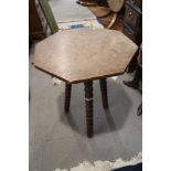 An oak octagonal top occasional table, on bobbin turned supports, 19" deep x 24" high, and an