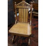 A 19th century oak hall chair, in the Pugin manner, with Gothic piercing and panel seat, on panel