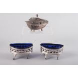 A pair of Georgian silver oval salts with pierced decoration and blue glass liners, a Georgian