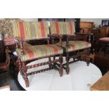 A pair of Restoration design carved walnut elbow chairs with lion mask terminals, stuffed over seats