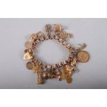 A yellow metal bracelet mounted numerous charms, including a 1903 half sovereign, 54g gross