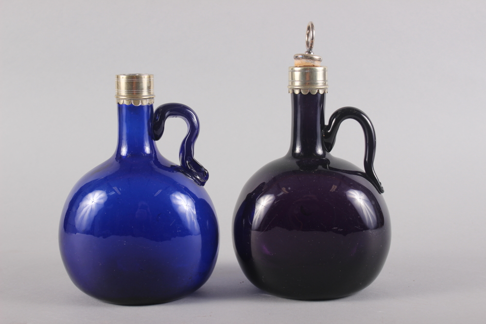 An amethyst glass and metal mounted bottle with stopper, 7" high, and another similar smaller blue