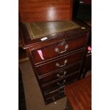 A polished as mahogany three-drawer filing cabinet with tooled leather top, 19" wide