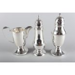 A silver baluster pepperette, 2.6oz troy approx, a silver dome top pepperette, on weighted base, and