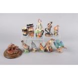 Seven Royal Worcester bone china model birds, including a kingfisher, pied woodpeckers, and a