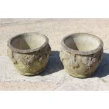 A pair of cast stone planters with grape decoration, 15" dia x 12" high