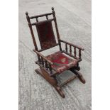 A child's walnut frame American rocking chair with Turkey seat and back panels