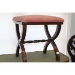 A mahogany 'X' frame stool, upholstered in a salmon velour