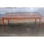 A cherrywood draw leaf dining table, on cabriole supports, 70" wide x 35" deep x 29 1/2" high when