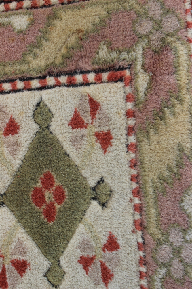 A Caucasian wool pile carpet with central guls and geometric and floral designs, on a terracotta - Image 4 of 6
