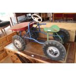 A child's 1960s pedal tractor with tip up bucket