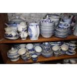 A quantity of mostly "Old Willow" pattern blue and white china, including tureens, teacups, plates