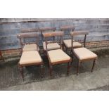 A set of six Regency mahogany standard chairs with carved back rails, on inverted tulip carved