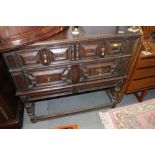 A Jacobean style oak chest of two short and one long drawer with fielded fronts, on turned