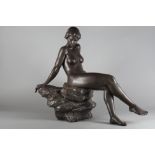 A bronzed Lladro sculpture of a nude woman resting on a rock, base signed "R, Torrijos No 98", 26"