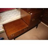 A mid 20th century cocktail cabinet and single drawer unit, on stand with ebonised supports, 48"