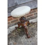 A 19th century carved rosewood circular adjustable piano stool, on tripod splay support, 17" wide