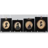 Two 19th century portrait miniatures of gentlemen, in ebonised frames, and a pair of silhouette