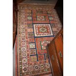 A Caucasian pile rug with three central medallions, geometric designs and multi-borders in shades of