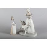 Two Lladro figure groups, "Shepherdess with Goats" 1001, 9 1/2" high, and "Girl with Pig" 1011