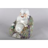 A Chinese porcelain seated Buddha, decorated polychrome enamels, impressed four-character mark to