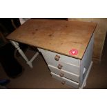 A cream painted pine single pedestal desk, fitted four drawers, 41" wide