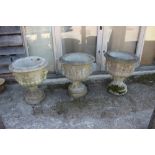 A set of three cast stone pedestal planters with lion mask and ring decoration, 21" dia x 25" high