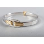 An Italian 18ct white gold bangle with yellow gold details, 15.6g