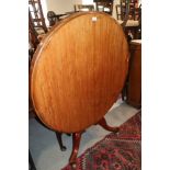 A 19th century mahogany circular tilt top dining table, on turned column and tripod splay support,