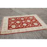 A Kashan Garous floral design rug with multi-borders on a red ground in shades of natural, 52 1/2" x