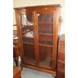 A walnut display bookcase/cabinet enclosed glazed doors, on cabriole supports, 37 1/2" wide