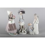 A Lladro figure group, "Girl with Umbrella" 4510, 10 1/2" high, a Lladro figure group, "Teaching