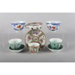 A pair of Chinese porcelain tea bowls, decorated bats and clouds with six-character mark to base,