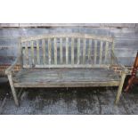 A teak slat back garden settle 37 1/2"h x 60"w x 24 1/2" deep