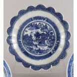 A 19th century blue and white porcelain dish with lobed edge and central willow pattern panel, 10"