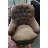 A Victorian button back armchair, upholstered in a dark brown velour, on turned supports