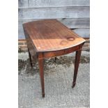 A Georgian mahogany oval Pembroke table, fitted one drawer, on square taper supports and brass